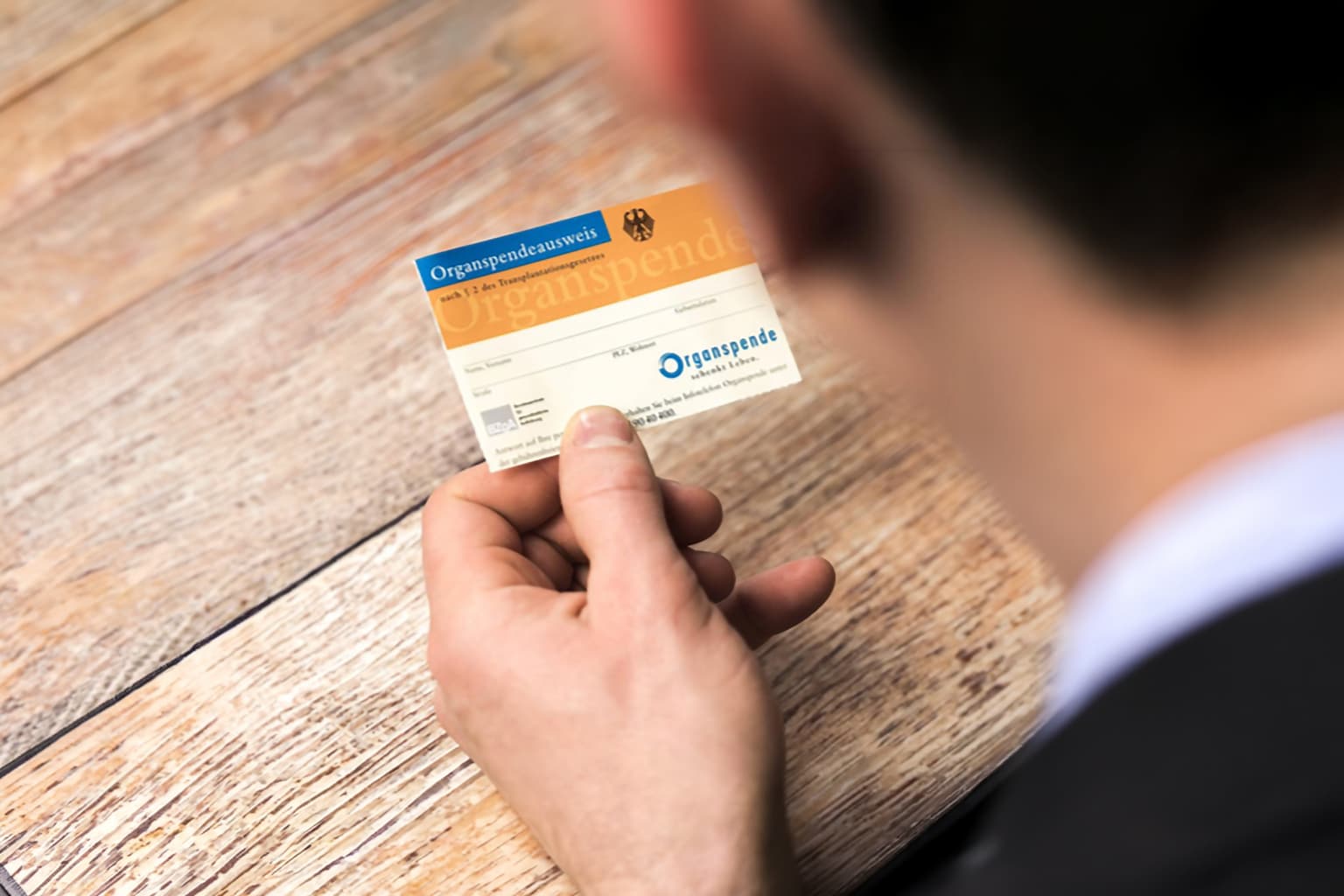 Person hält Organspendeausweis in der Hand, Fokus auf Gesundheitsvorsorge und Beratung in Hilden und Düsseldorf.